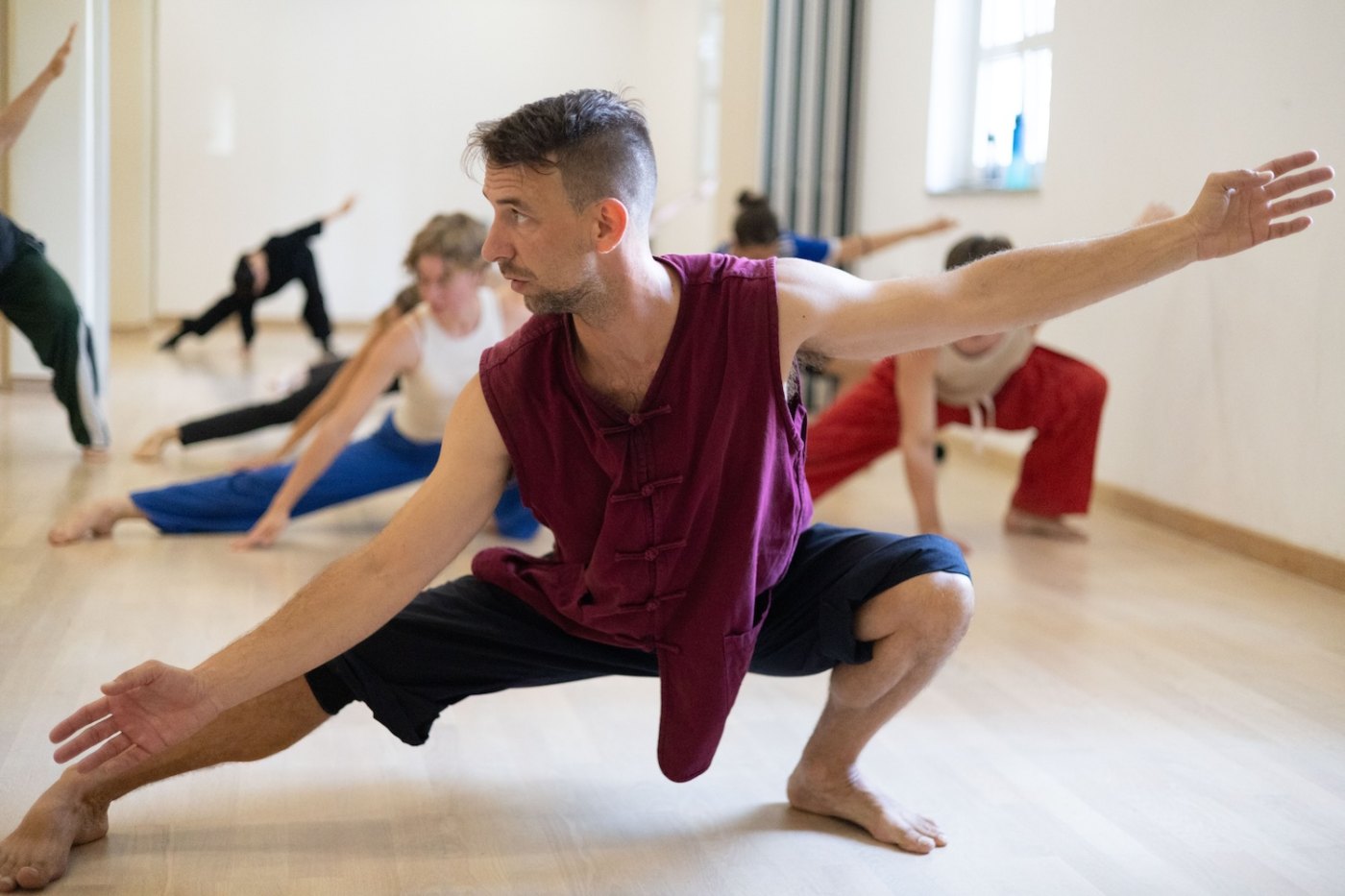 A student holding a low stance during Kung Fu training