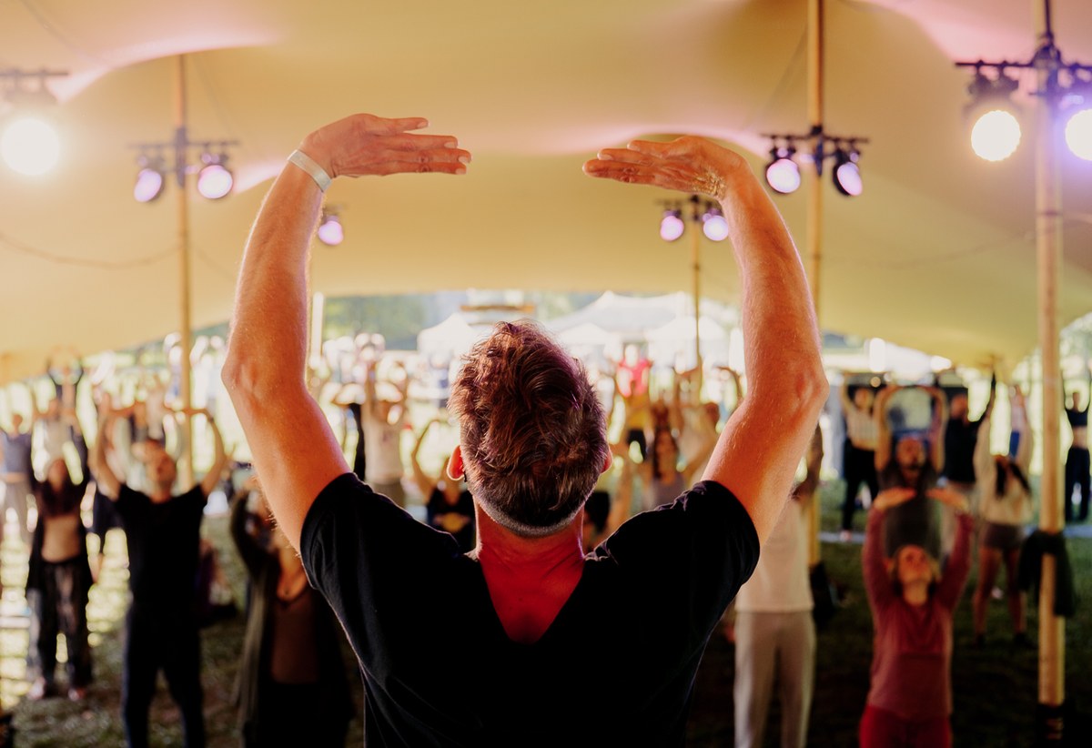 Qi Gong - practitioner mid-movement with one arm raised, black-and-white